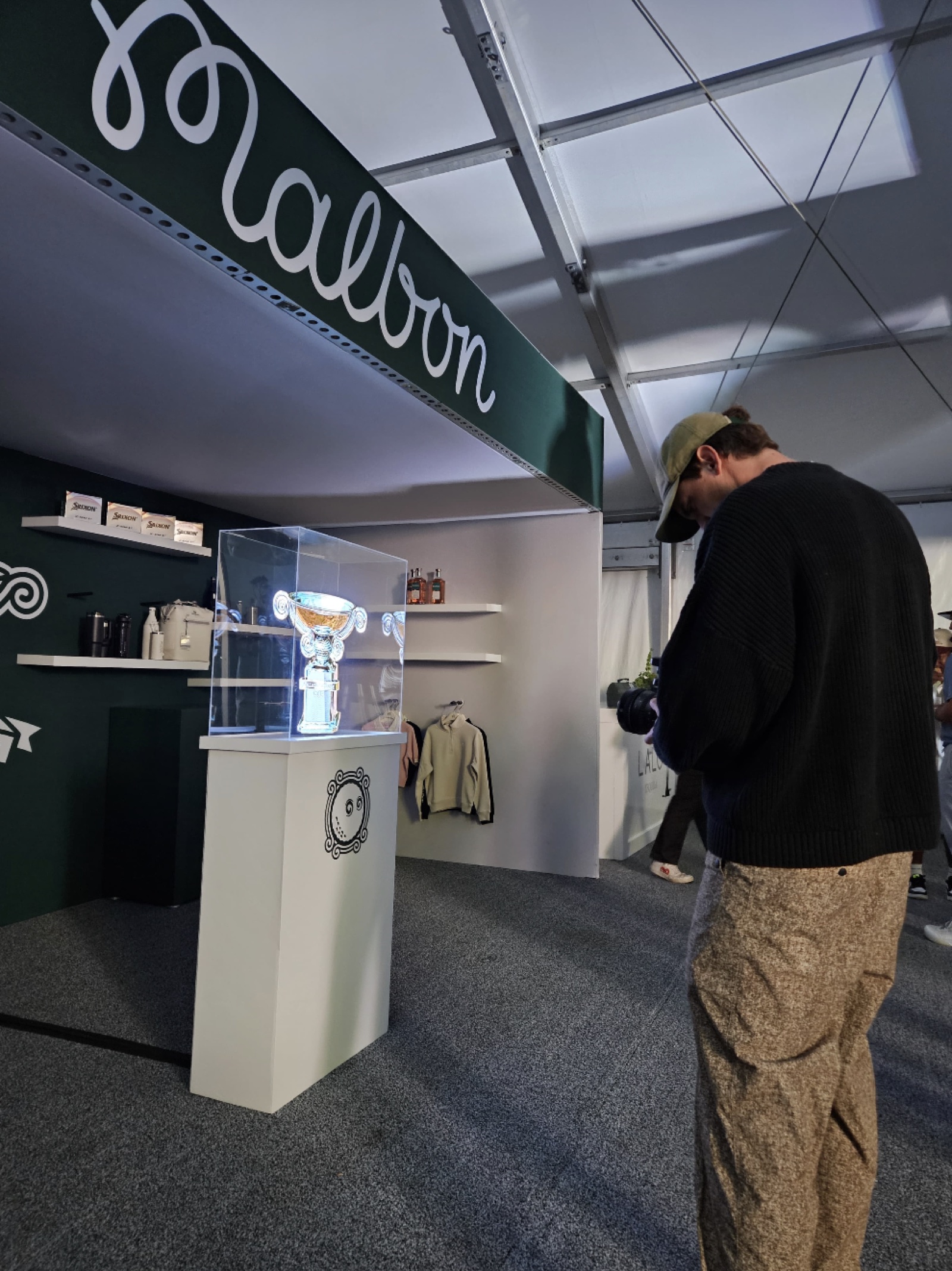 A compact holographic display integrated into the Malbon booth
